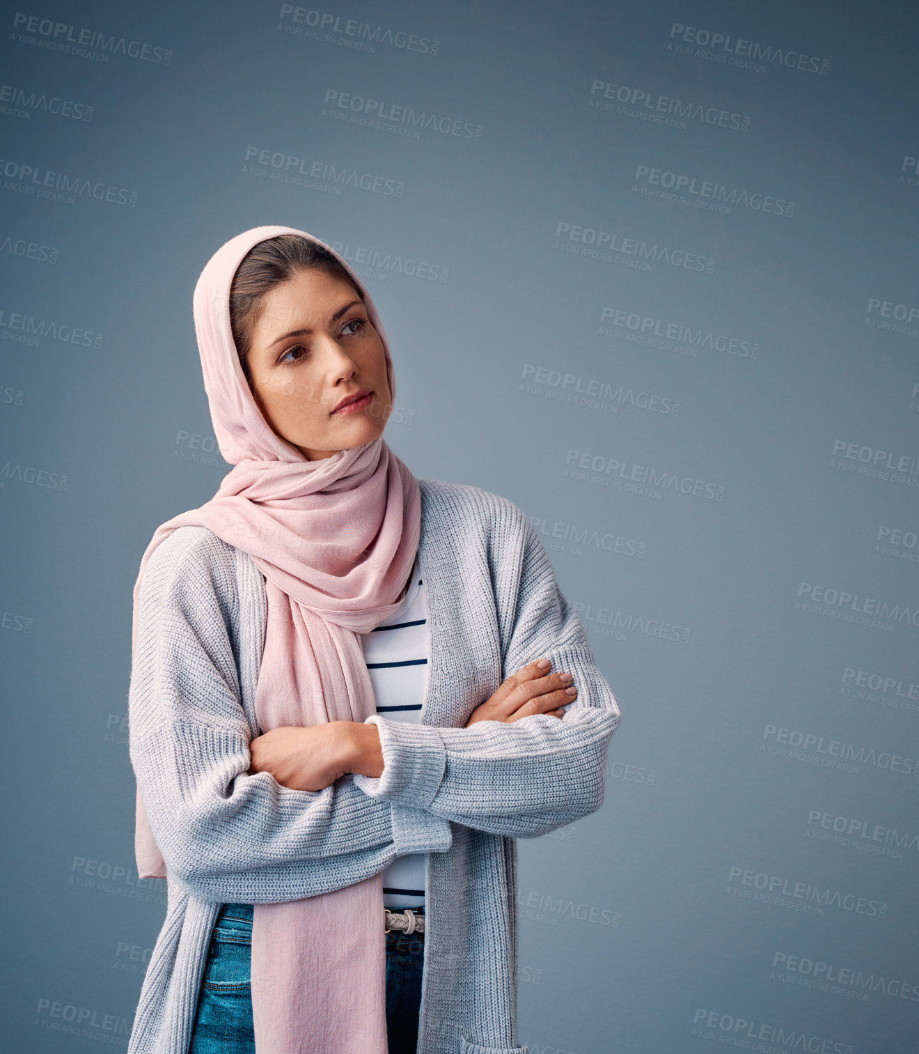 Buy stock photo Thinking, hijab and muslim woman with arms crossed in studio for reflection, decision or memory on blue background. Islam, serious and Arab female person for dreams, thoughtful or future plans