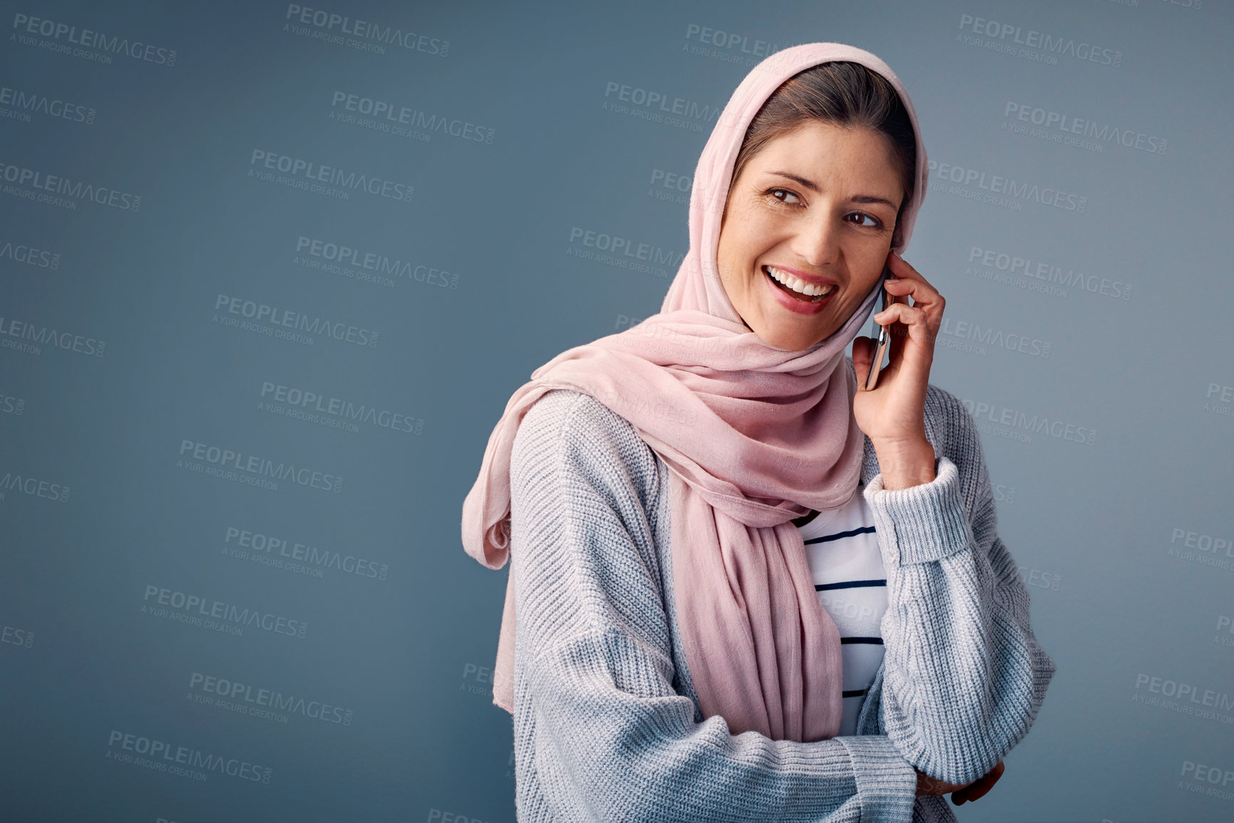 Buy stock photo Muslim woman, studio and thinking on phonecall with smile for startup, small business idea or vision. Female entrepreneur and backdrop with mobile and plan for fashion design in France or Europe