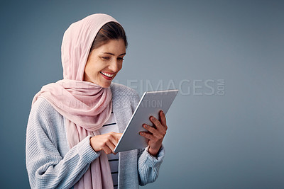 Buy stock photo Muslim, woman and reading online with tablet on streaming ebook or watch video on web. Contact, communication and girl relax with mobile app or chat on internet in studio background or mockup space