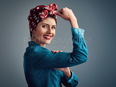 Buy stock photo Strong, pinup girl and flexing muscle portrait of a woman in studio for beauty, power and fashion. Happy female person show bicep on grey background for motivation, freedom and retro or vintage style