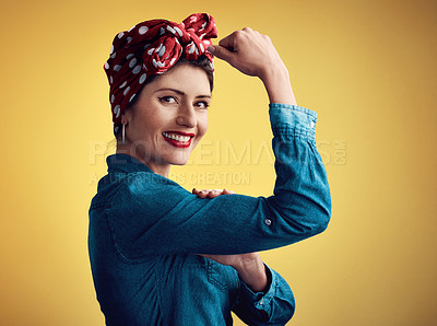 Buy stock photo Strong, pinup girl and flexing muscle portrait in studio for beauty, women power and fashion. Happy female person show bicep on yellow background for motivation, freedom and retro or vintage style