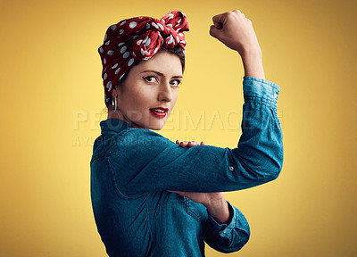 Buy stock photo Woman, strong and flexing muscle portrait of a pinup girl in studio for beauty, power and fashion. Female person show bicep on a yellow background for motivation, freedom and retro or vintage style