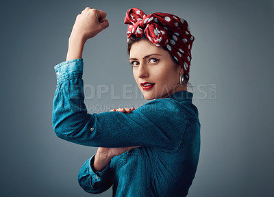 Buy stock photo Flexing, strong and portrait of a pinup girl with muscle in studio for support, women power and fashion. Female person show bicep on grey background for motivation, freedom and retro or vintage style