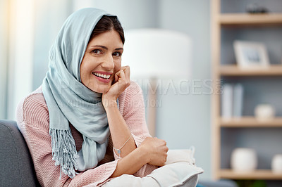 Buy stock photo Muslim, woman and portrait in living room for relax, weekend  and happiness on sofa in apartment. Hijab, peace and smile in house for morning zen, wellness and lounge indoors for break from work. 