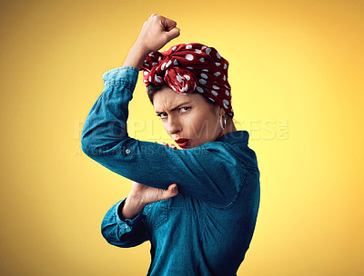 Buy stock photo Pinup girl, strong and flexing muscle portrait in studio for support, women power and fashion. Angry female person show bicep on yellow background for motivation, freedom and retro or vintage style