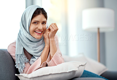 Buy stock photo Portrait, woman and hijab in living room for relax, weekend  and happiness on sofa in apartment. Arab female person, peace and smile in house for morning zen, content and lounge indoors for enjoyment