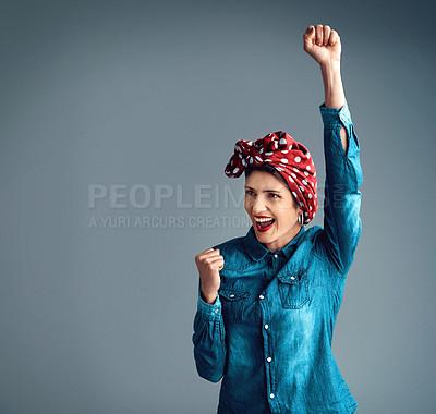 Buy stock photo Woman, feminism and fist for community support, protest or celebration in grey studio background. Female person, smile and arm up in head scarf for revolution, power to the people or strong together