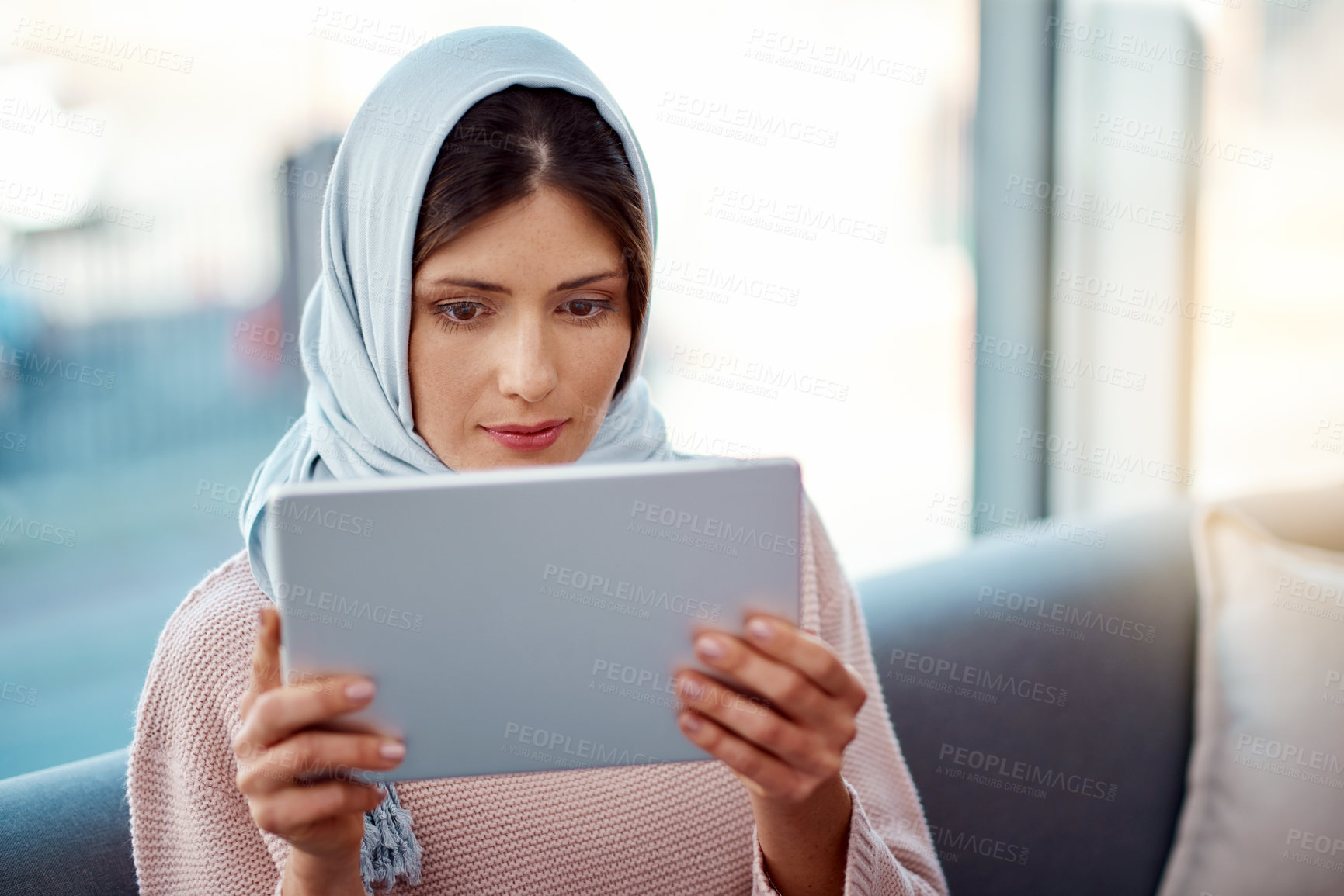 Buy stock photo Relax, tablet and muslim woman on sofa in living room streaming movie, film or show for entertainment at home. Rest, digital technology and islamic female person watching video online at apartment.