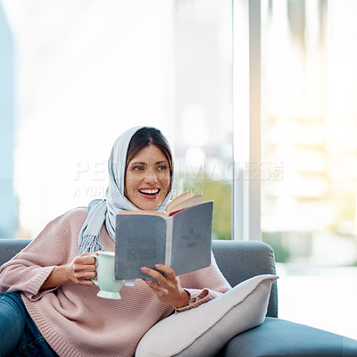 Buy stock photo Happy, reading and muslim woman with coffee and book on sofa relaxing in living room at home. Smile, cappuccino and islamic female person enjoying literature, novel or story on couch at apartment.
