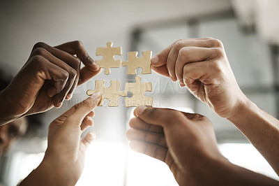 Buy stock photo Diverse business people coming together as a team, planning for the future and collaborating to complete a puzzle closeup. Corporate professionals in unity holding up and supporting pieces of a whole