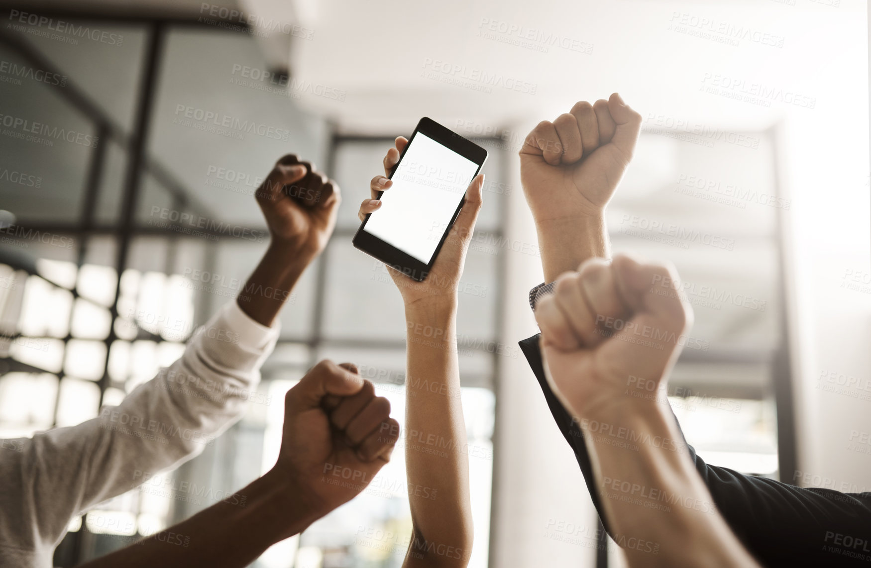 Buy stock photo Hands of business people cheering, celebrating good news on a phone with blank screen for copy space. Excited team of office workers showing power fist gesture for success, victory and winning