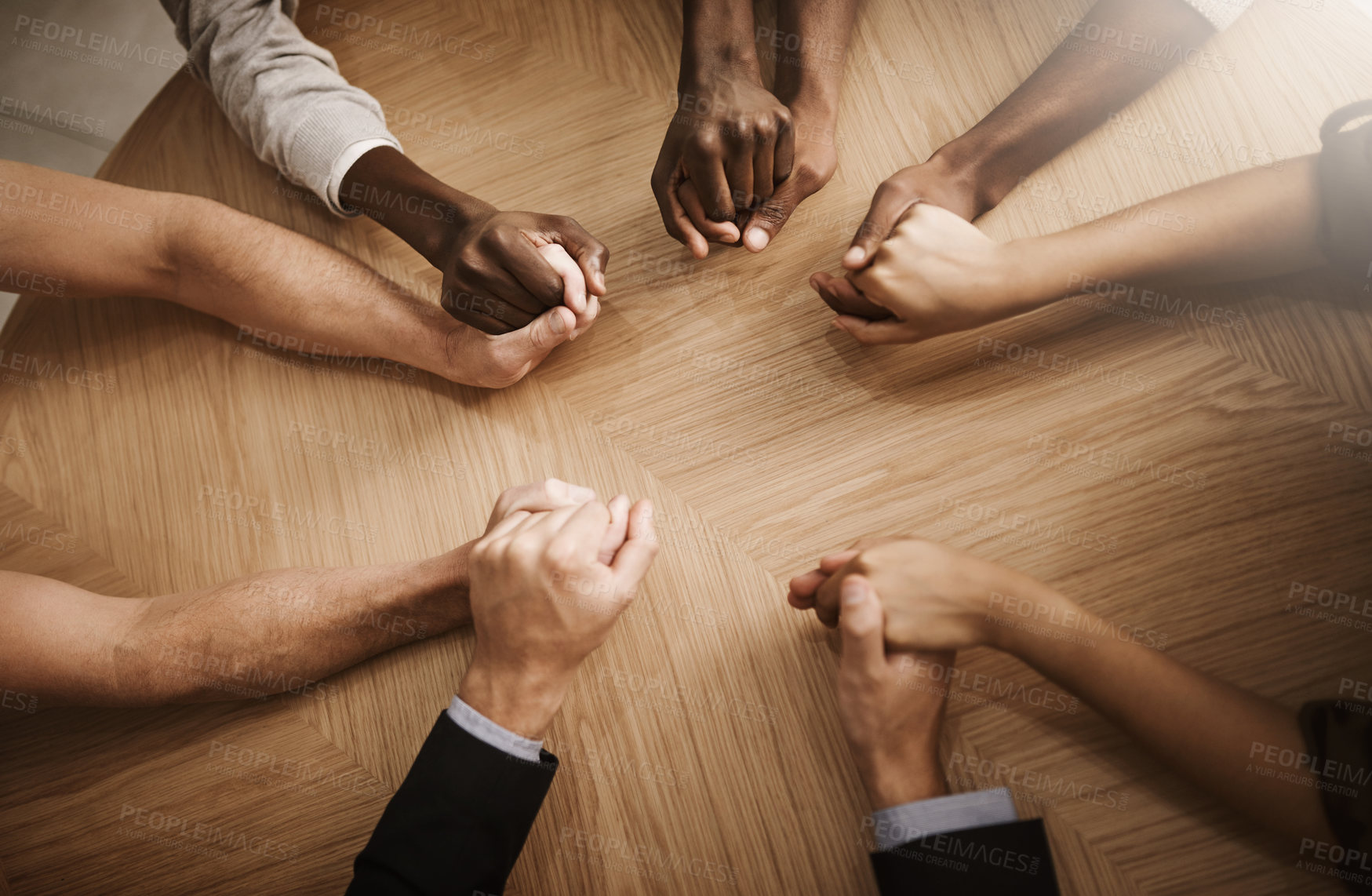 Buy stock photo Cropped shot of a group of businesspeople holding their hands in solidarity