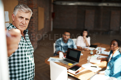 Buy stock photo Shot of a businessman giving a presentation in the boardroom