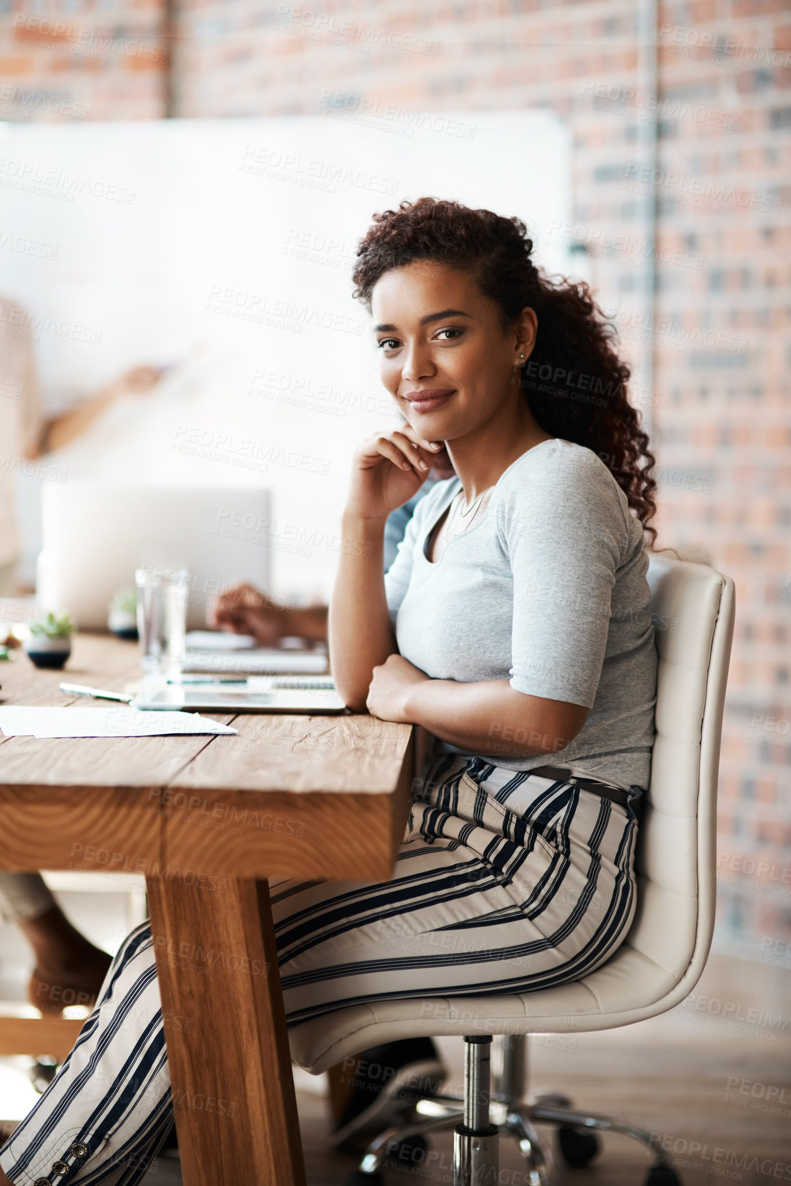 Buy stock photo Portrait of a young businesswoman sitting in a meeting in the boardroom