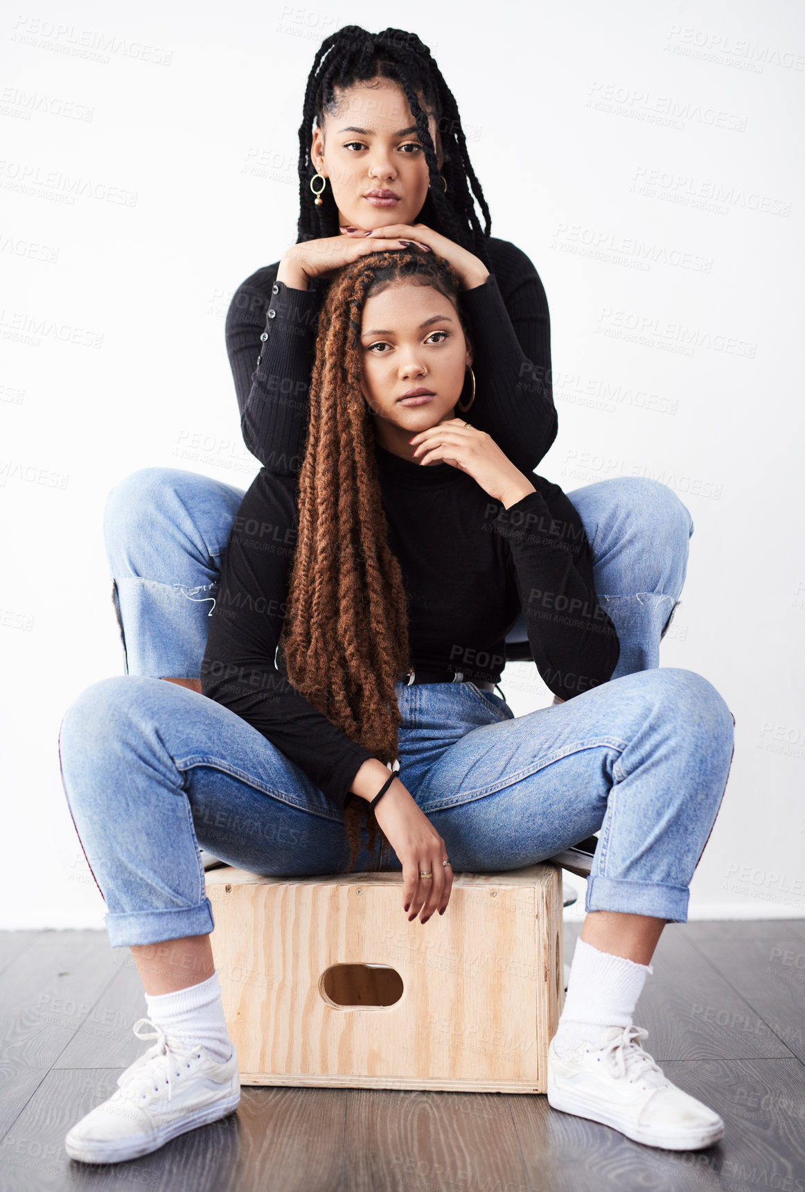 Buy stock photo Lesbian couple, portrait and fashion in studio with confidence for style inspiration, white sneakers and love. Serious, lgbt and black people together for support, relationship and braids with jeans