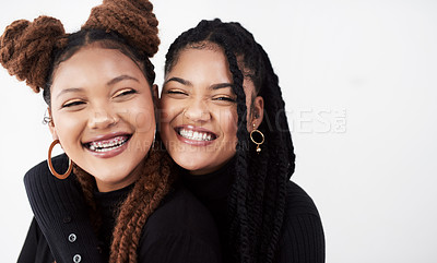 Buy stock photo Lesbian couple, face and fashion in studio with hug for style inspiration, happiness and love together. Serious, lgbt and black people with embrace for support, relationship and braids with smile