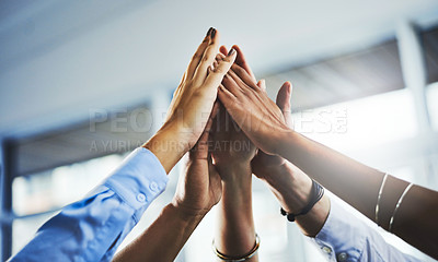 Buy stock photo Closeup shot of a group of businesspeople high fiving each other in an office