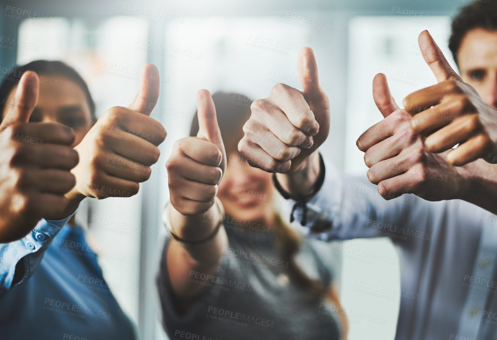 Buy stock photo Closeup shot of a group of businesspeople showing thumbs up in an office