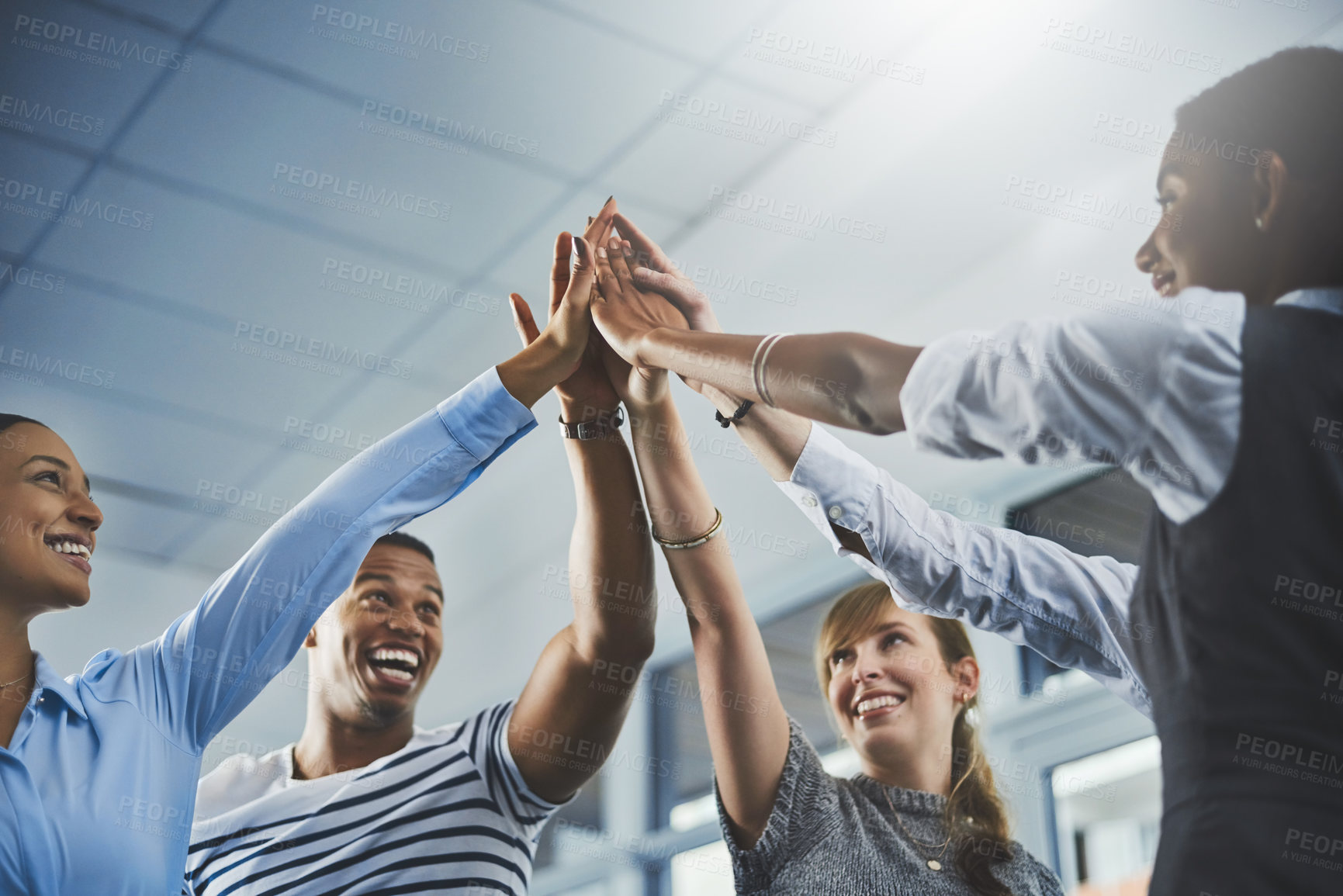 Buy stock photo Closeup shot of a group of businesspeople high fiving each other in an office