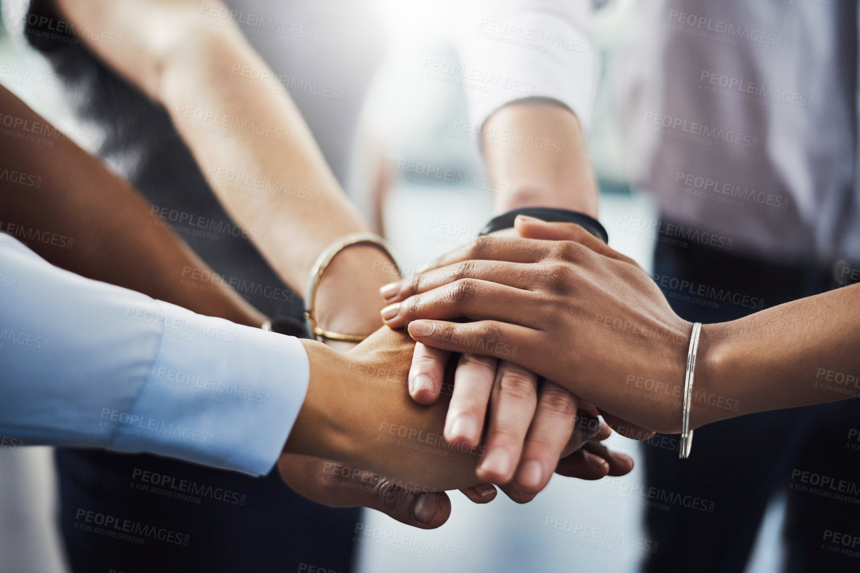 Buy stock photo Closeup shot of a group of businesspeople joining their hands together in a huddle