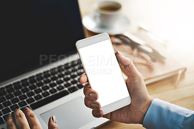 Buy stock photo Closeup shot of a businesswoman using a laptop and cellphone