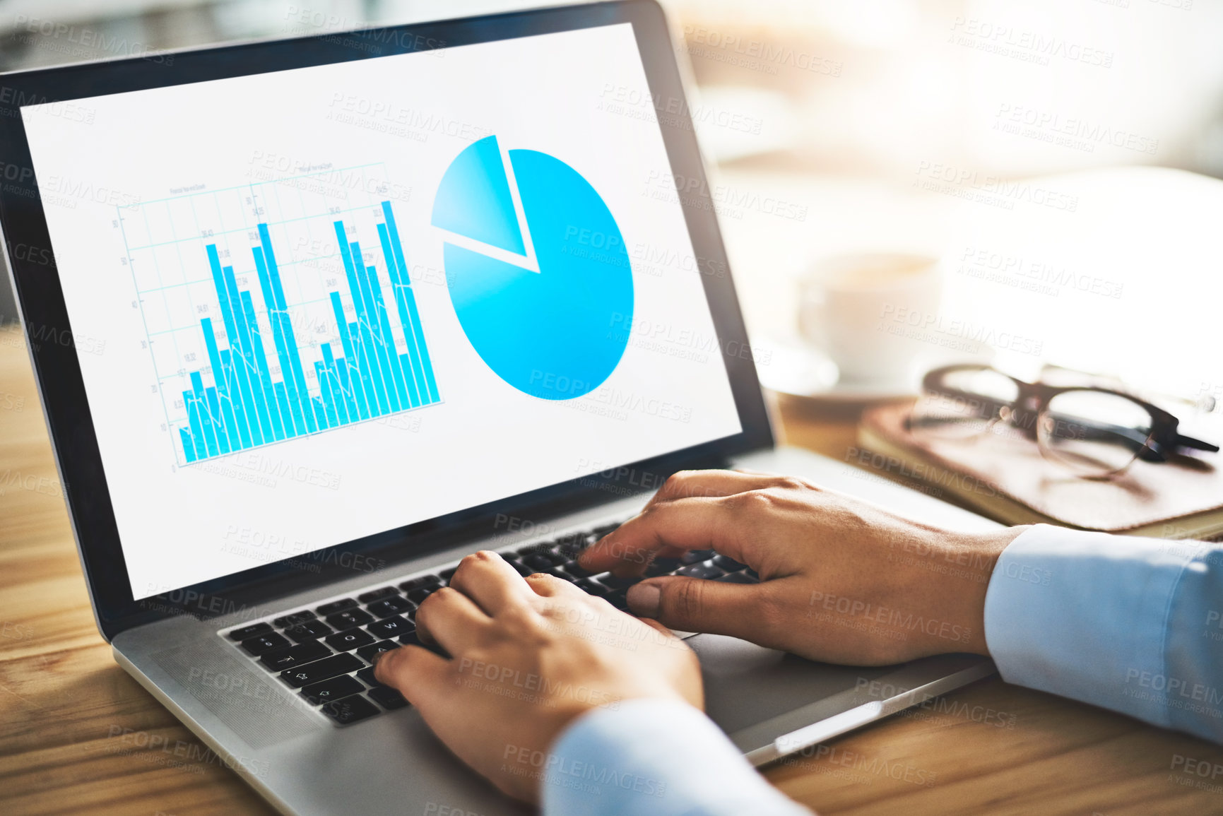 Buy stock photo Closeup shot of a businesswoman working with graphs on a laptop in an office