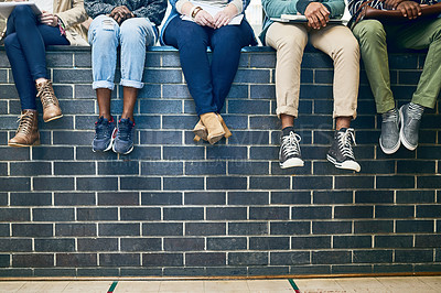 Buy stock photo Closeup, legs and students with education, wall and knowledge on a break, relax and university. Zoom, group and young people with sneakers, shoes and campus with fashion, scholarship and opportunity
