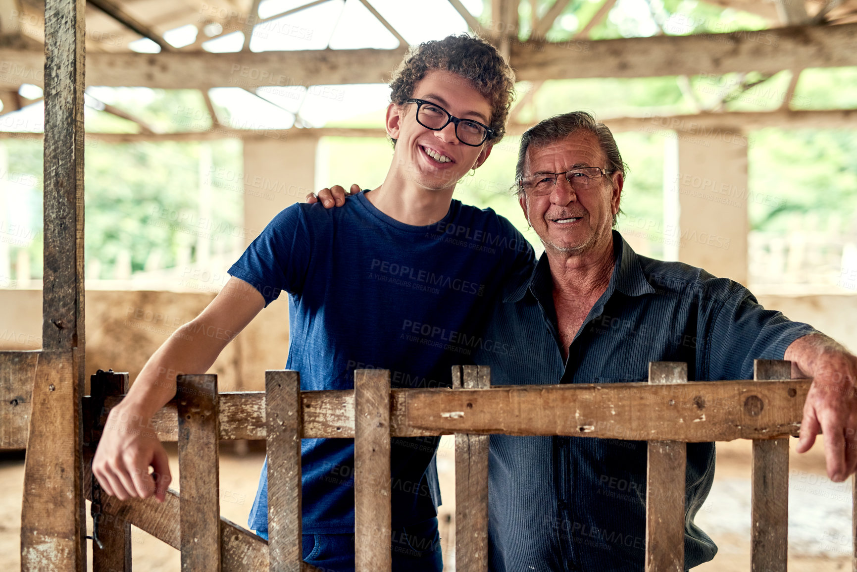 Buy stock photo Portrait of a farmer and his son inside a barn