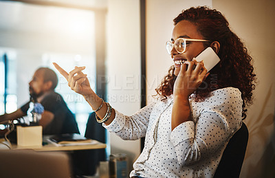 Buy stock photo Shot of a young businesswoman using a mobile phone during a late night at work
