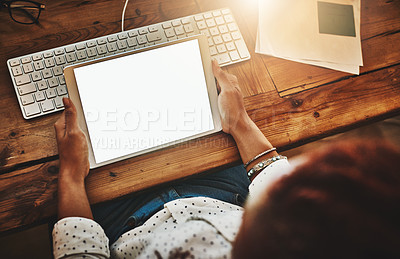 Buy stock photo Cropped high angle shot of a businesswoman using a digital tablet during a late night at work