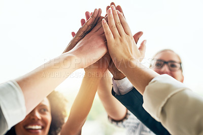 Buy stock photo Cropped shot of a group of unrecognizable businesspeople high fiving while standing in their office