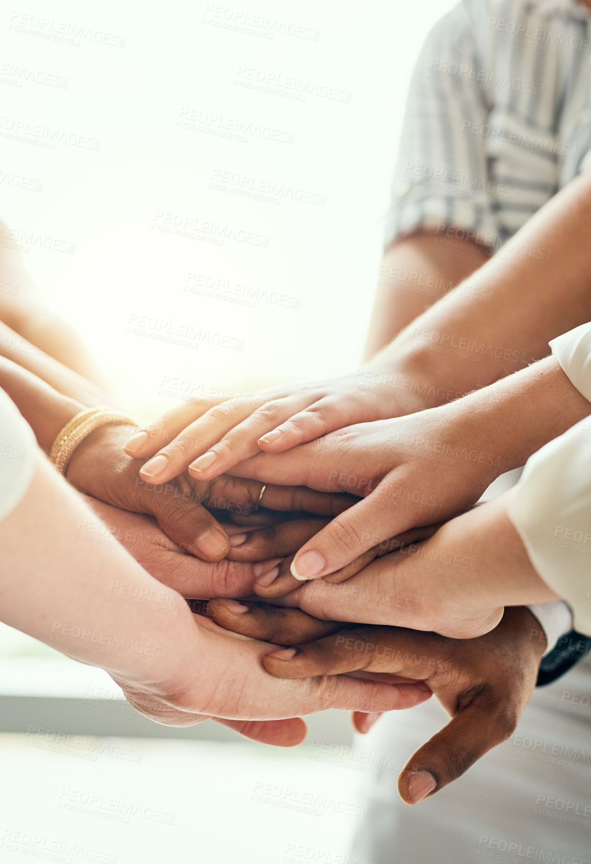 Buy stock photo Cropped shot of a group of unrecognizable businesspeople standing in the office with their hands in a huddle