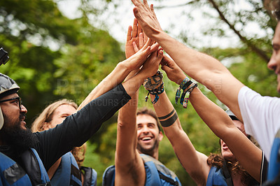 Buy stock photo Cropped shot of a group of young friends high fiving while out white water rafting