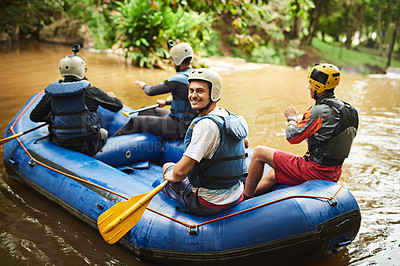 Buy stock photo High angle portrait of a handsome young man and his friends sitting in their white water raft