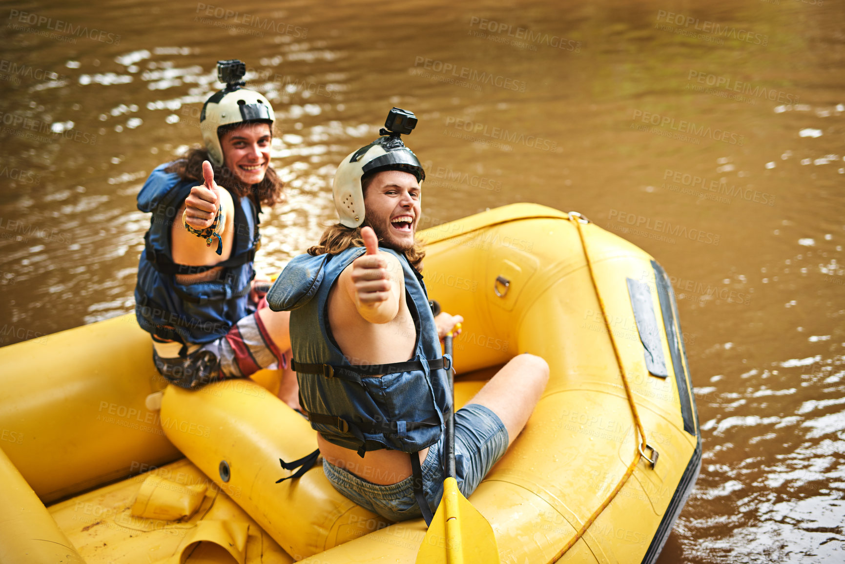 Buy stock photo Rearview portrait of two young friends giving you the thumbs up while sitting in their white water raft