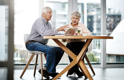 Buy stock photo Full length shot of a senior couple working on their finances at home