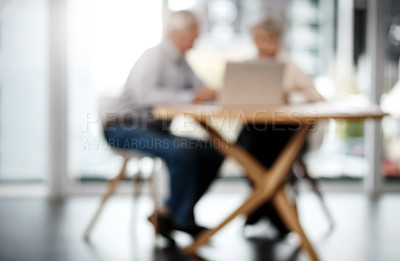 Buy stock photo Full length shot of an unrecognizable senior couple working on their finances at home