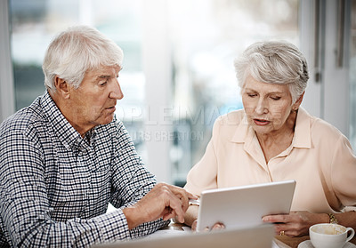 Buy stock photo High angle shot of a senior couple working on their finances at home