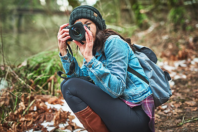 Buy stock photo Cropped shot of a young woman taking a picture in the outdoors