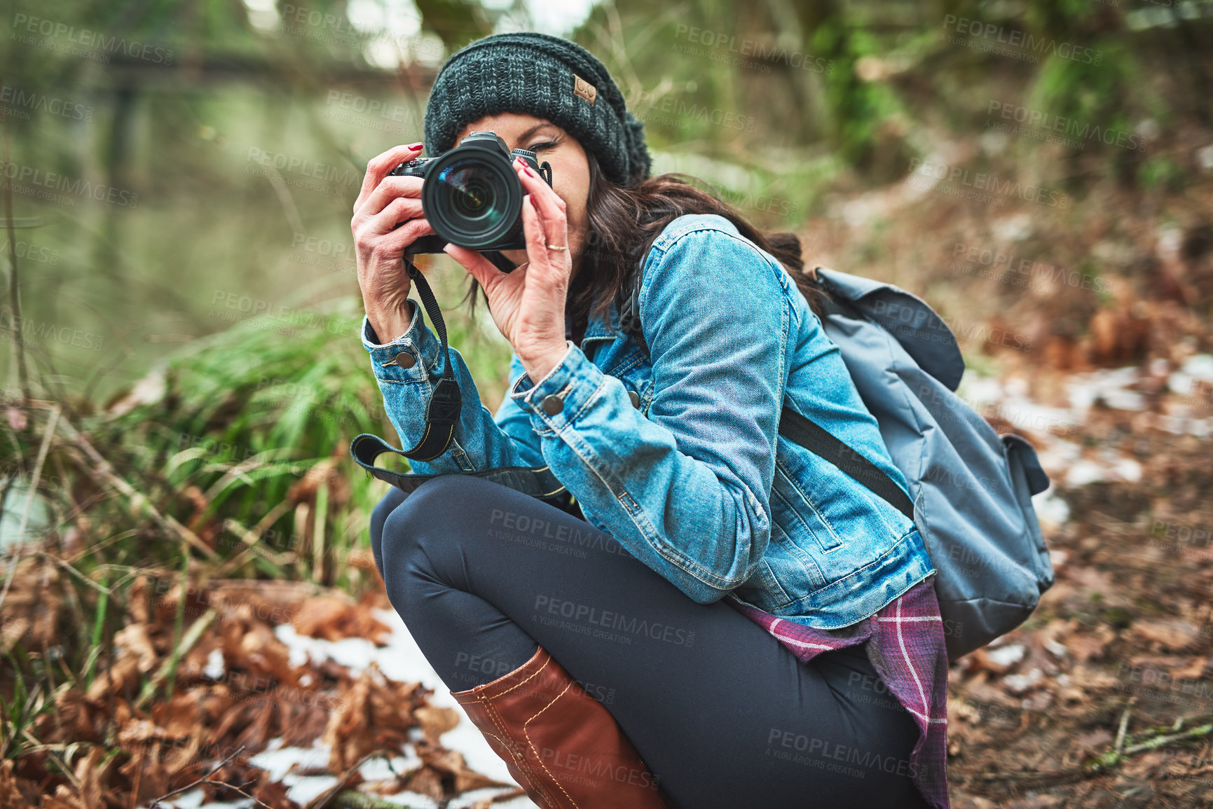 Buy stock photo Cropped shot of a young woman taking a picture in the outdoors