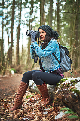 Buy stock photo Shot of a young woman taking a picture in the outdoors