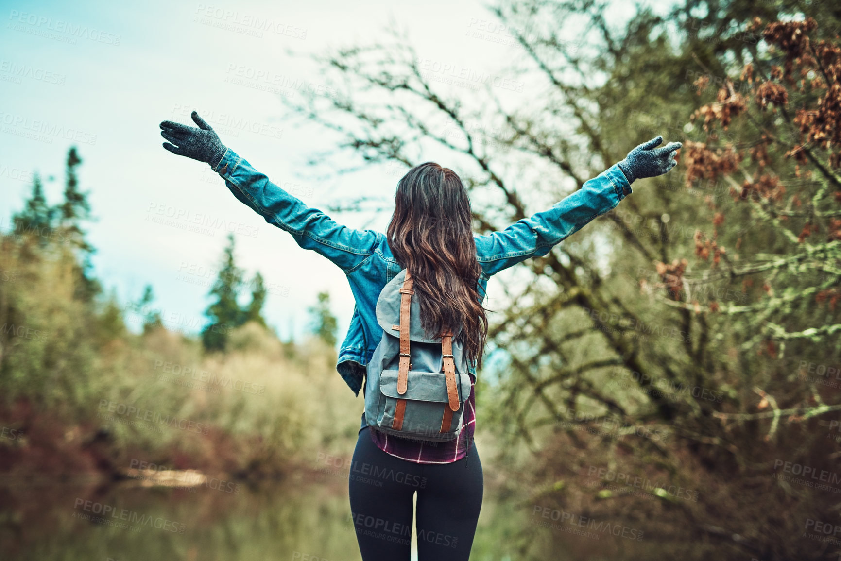 Buy stock photo Woman, backpack and hiking with arms raised by lake for goal, success or memory on vacation in nature. Person, cheers and bag for achievement by water, river or celebration on adventure in Costa Rica