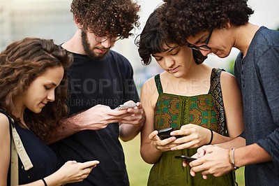 Buy stock photo Cropped shot of a college students using cellphones outside