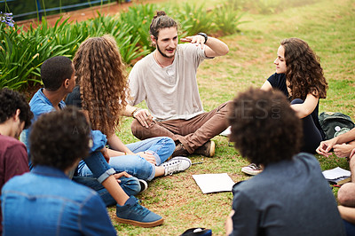 Buy stock photo Cropped shot of a group of college students having a discussion while sitting in a circle outside