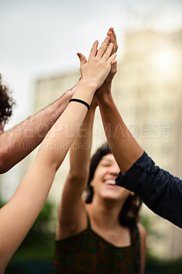 Buy stock photo Cropped shot of a group of college students giving each other a high five outside