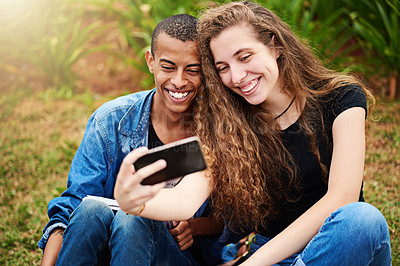 Buy stock photo Cropped shot of a young couple taking a selfie outside