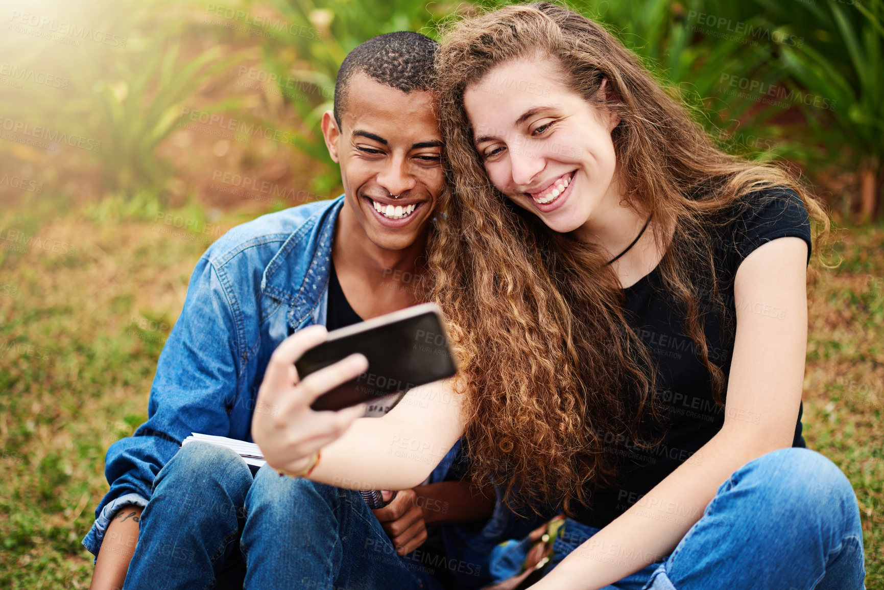 Buy stock photo Cropped shot of a young couple taking a selfie outside