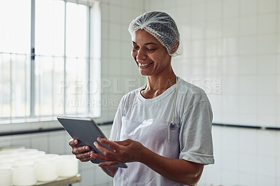 Buy stock photo Cheese, factory and woman with tablet, production and employee with apron, recipe and preparation with digital. Process, gourmet and professional with smile, fromager and work in kitchen and online