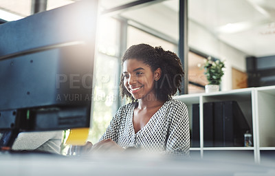 Buy stock photo Cropped shot of a young businesswoman working on her computer at her desk