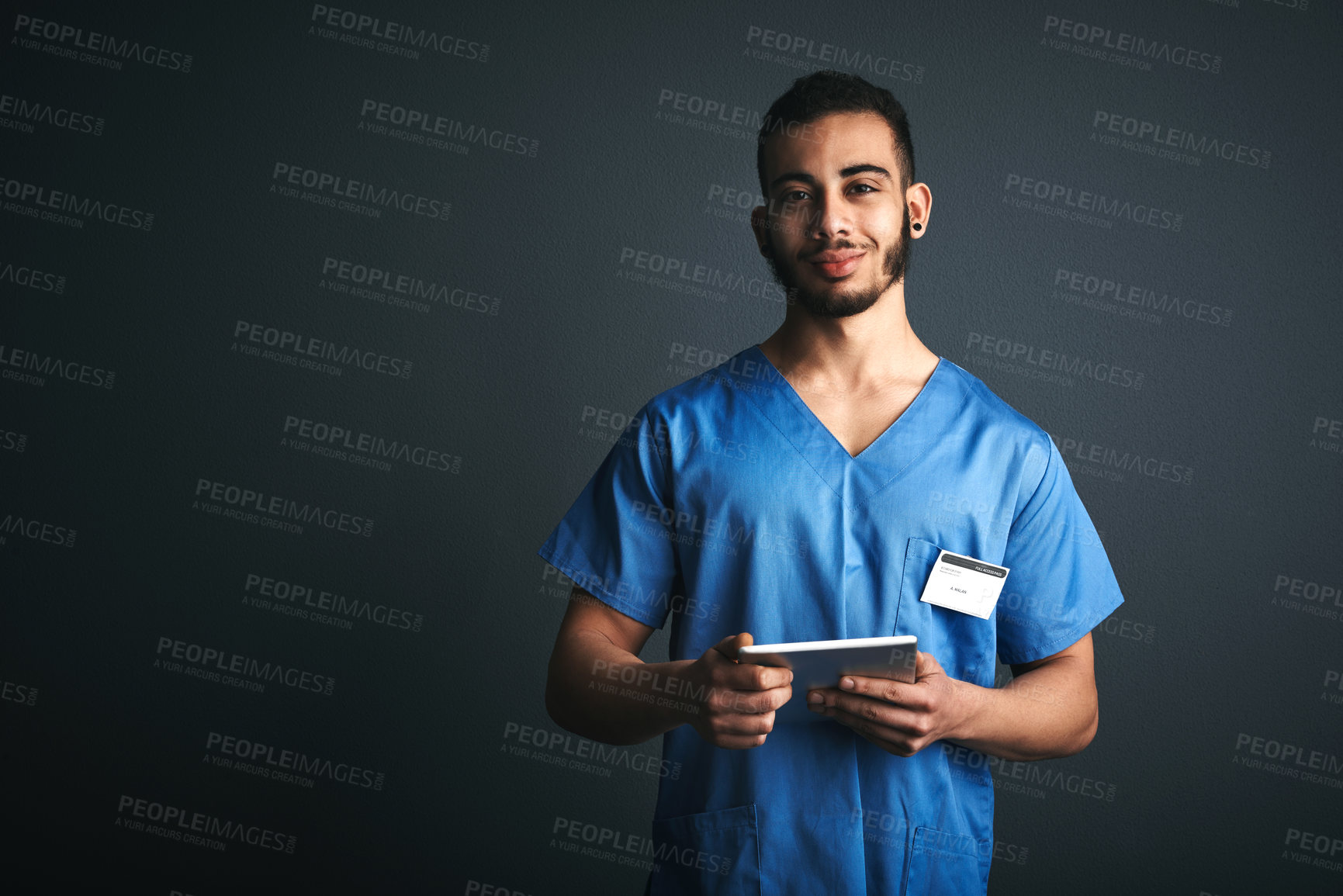Buy stock photo Portrait, doctor and man with tablet in studio, healthcare professional and confident for clinical study. Medical resident, research or happy student with tech for education, space or gray background